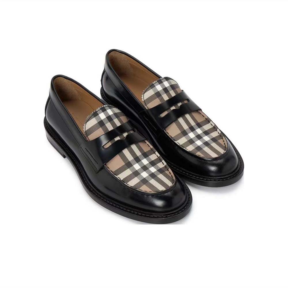 Close-up of black leather and Burberry check panel detail on loafer