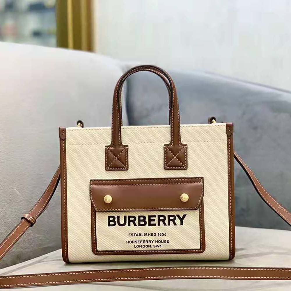 Close-up of gold Burberry logo hardware on Mini Freya Tote-Beige