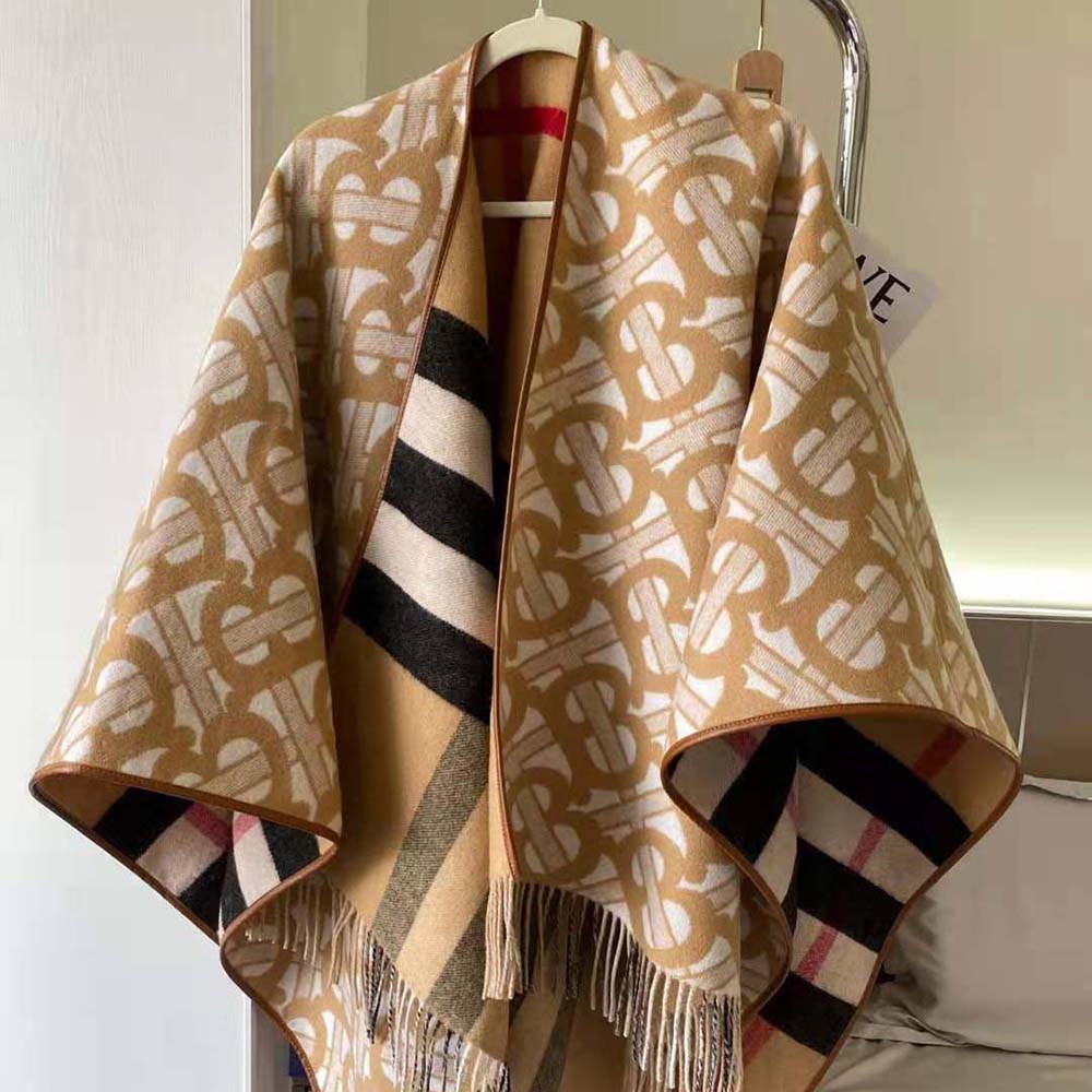 Close-up of monogram detailing on reversible Burberry cape beige