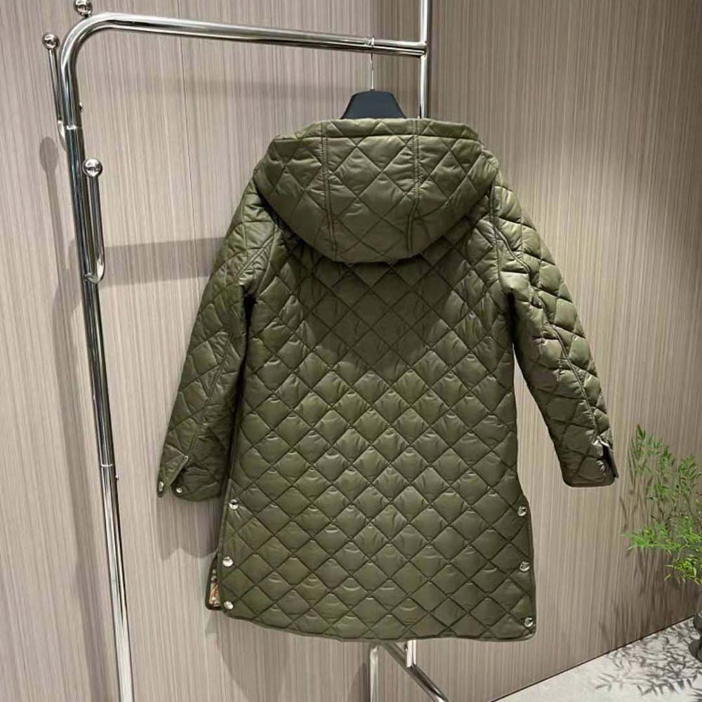 Side angle showing hood and relaxed silhouette of Burberry coat