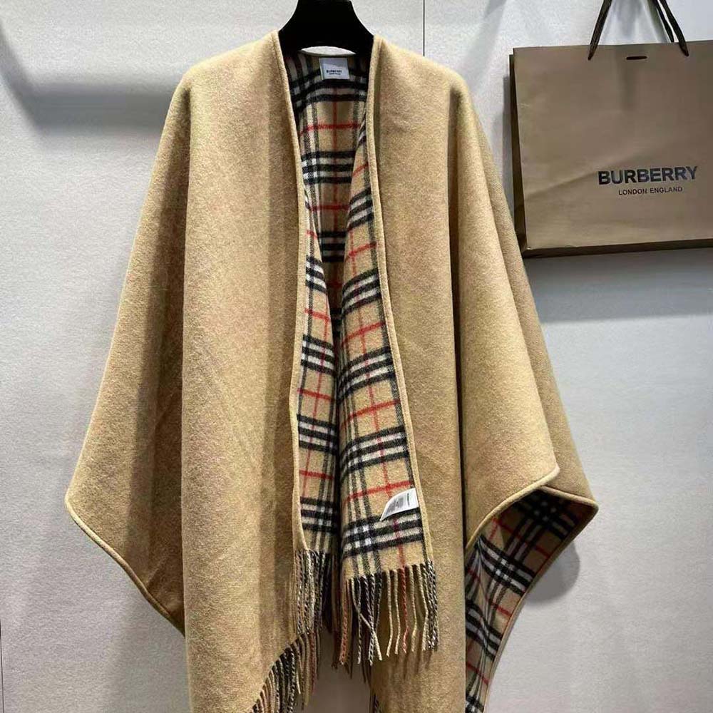 Close-up detail of Burberry check pattern and wool texture on reversible cape