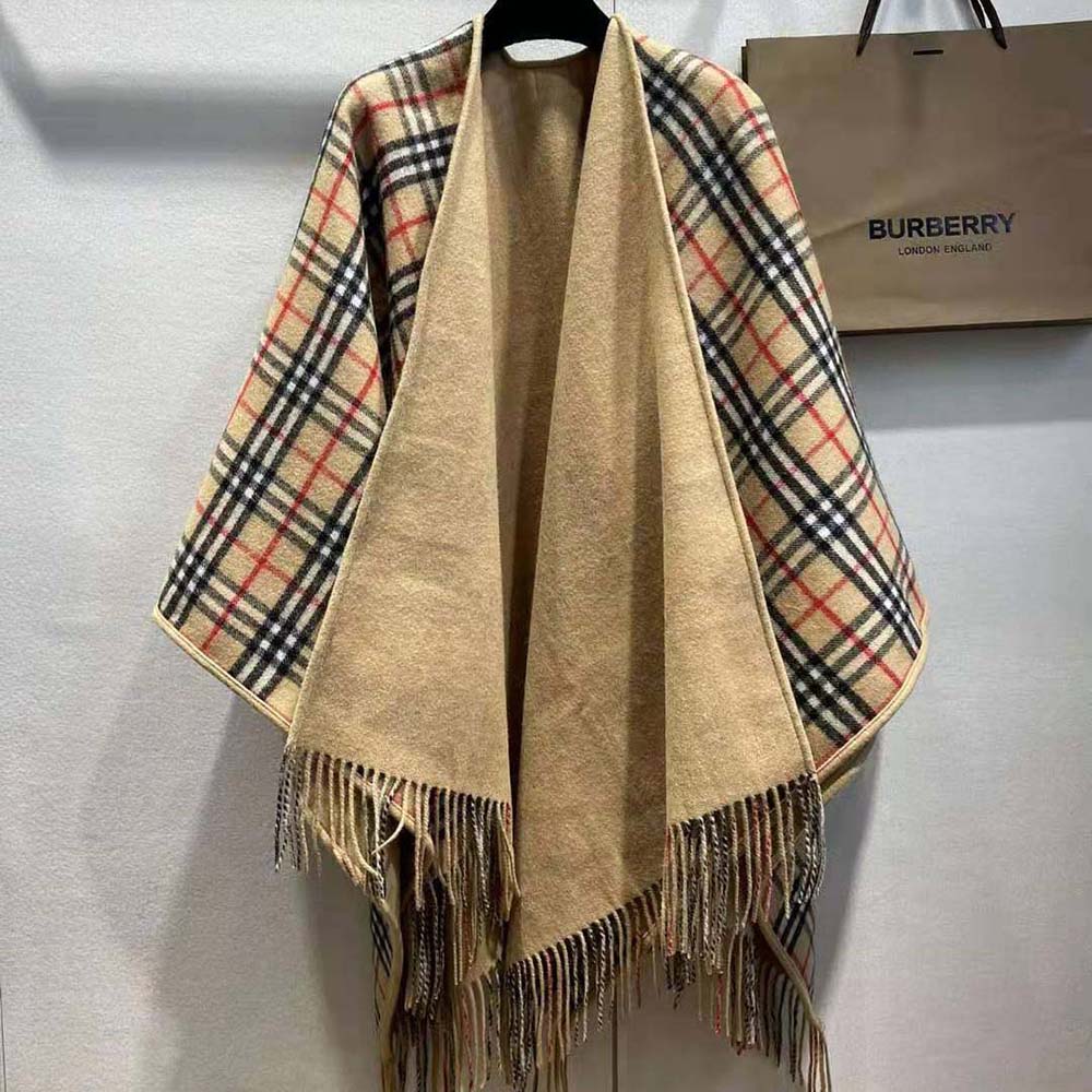 Side angle showing flowing silhouette of Burberry Women Reversible Check Wool Cape-Beige