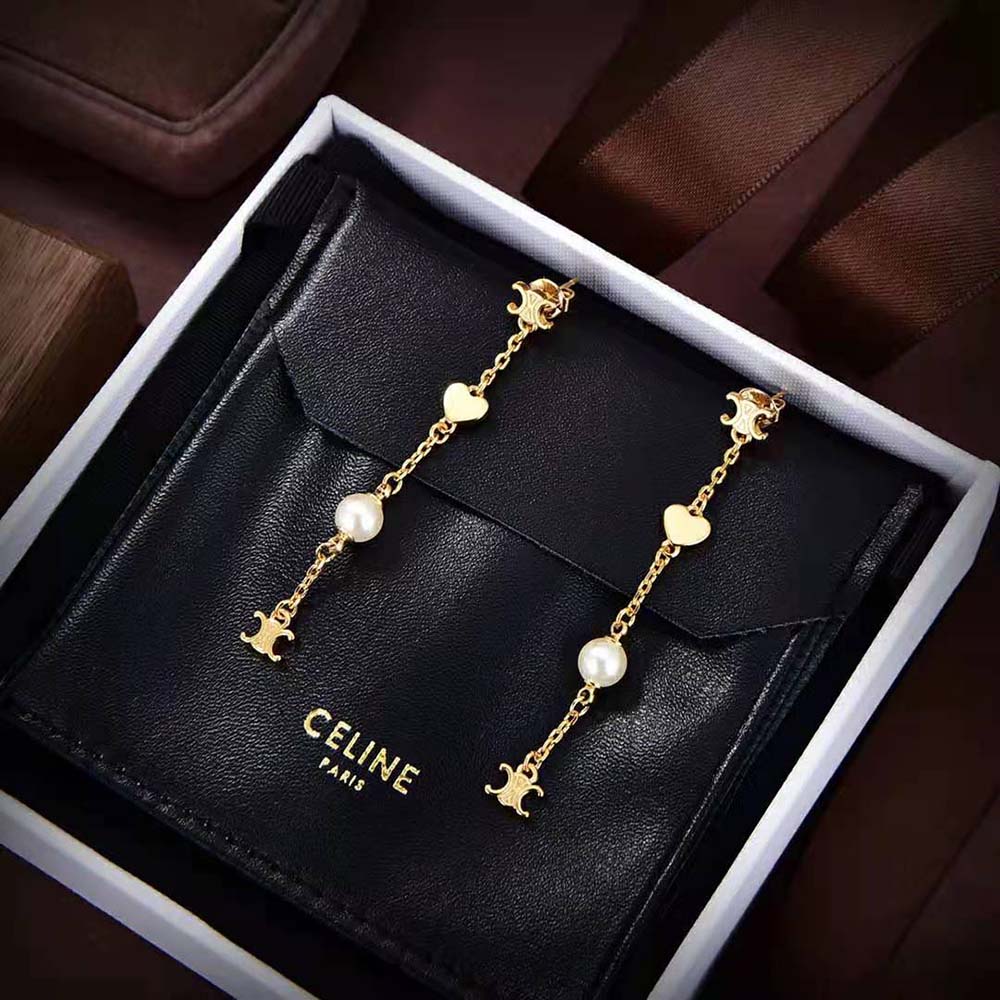 Side angle showing drop silhouette of Celine Women Cœur Charms Earrings