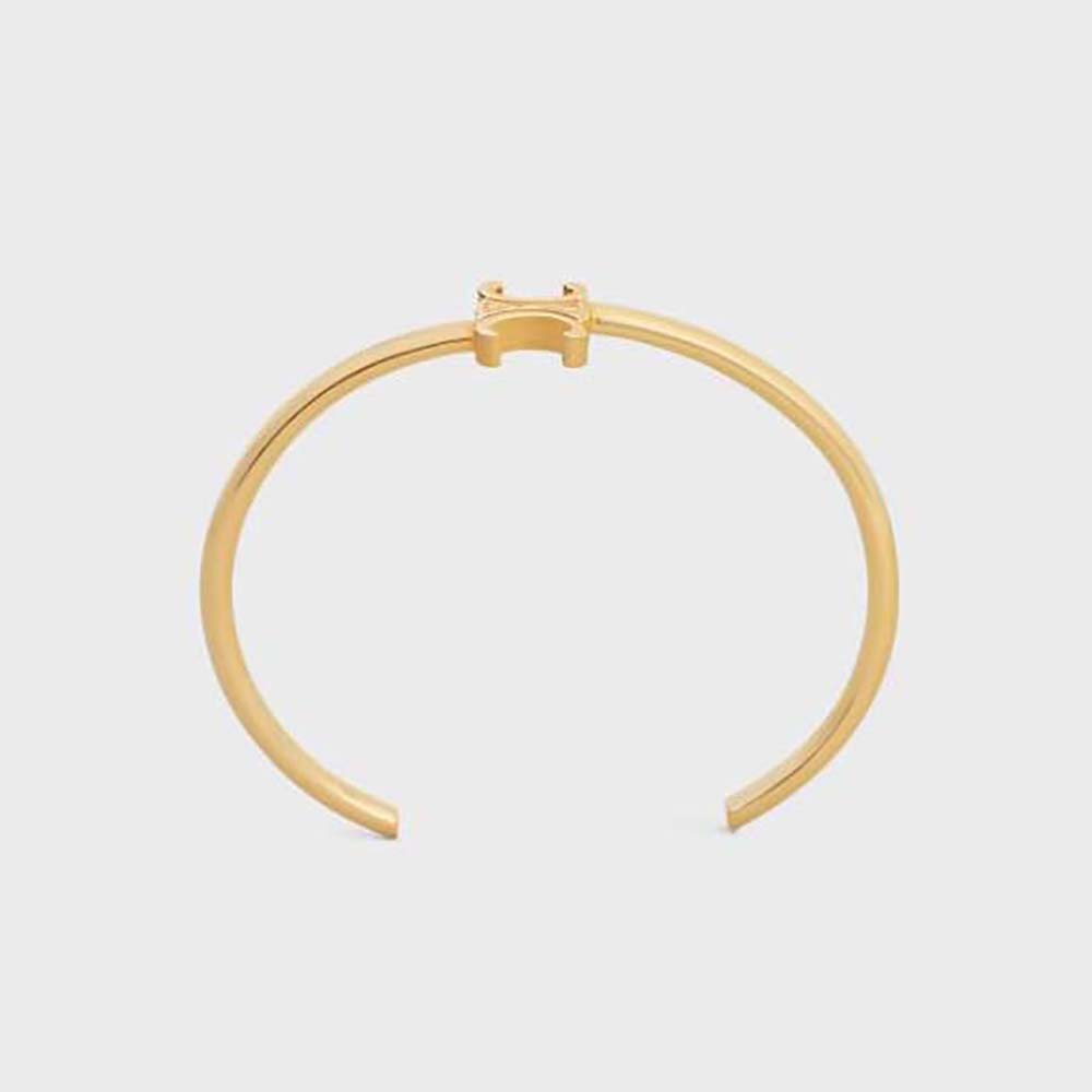 Close-up of Celine Women Triomphe Asymmetric Cuff gold finish detail