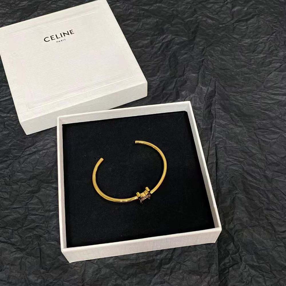 Angled view showcasing Celine Women Triomphe Asymmetric Cuff open design