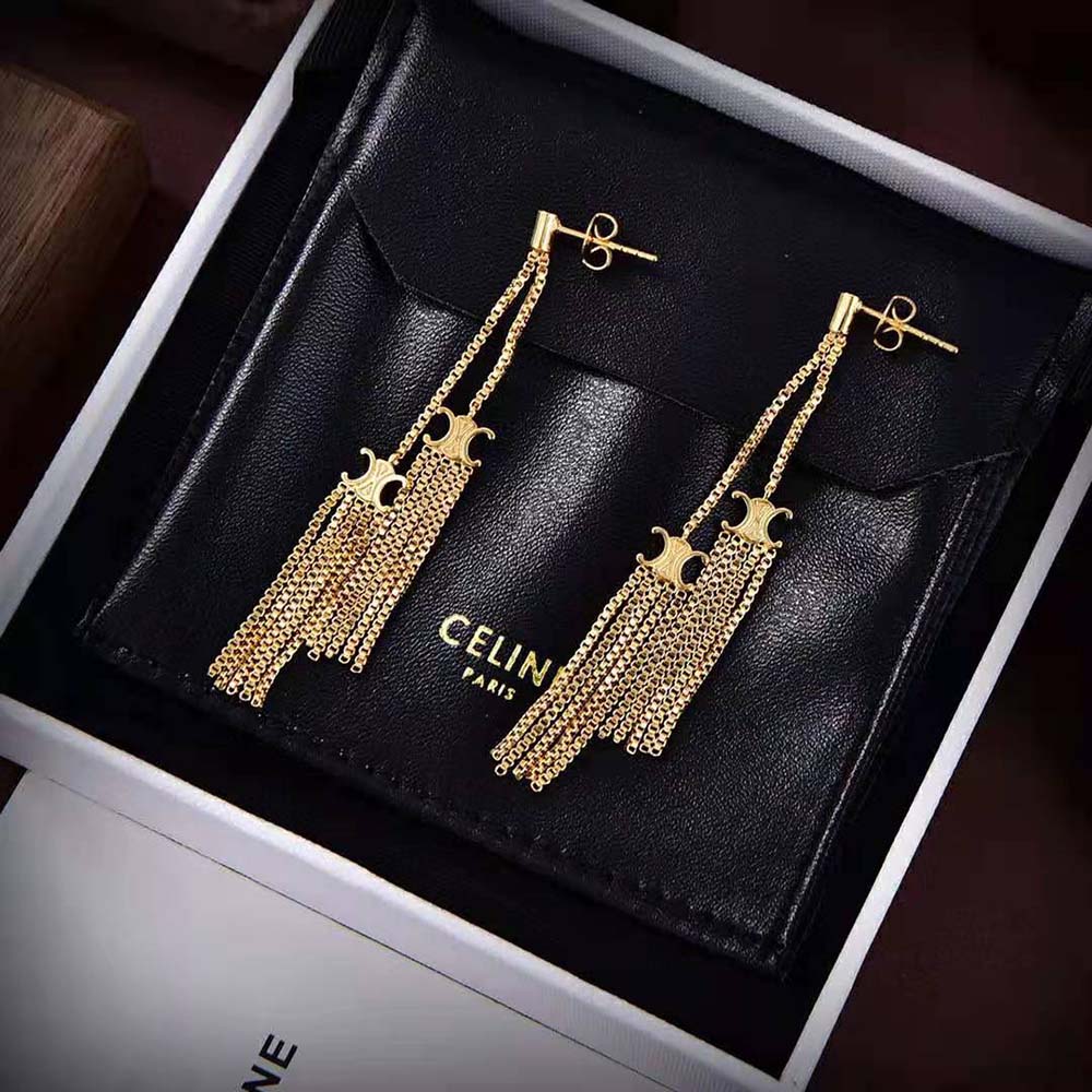 Side profile showing the silhouette of Celine Women Triomphe Folk Pompon Earrings