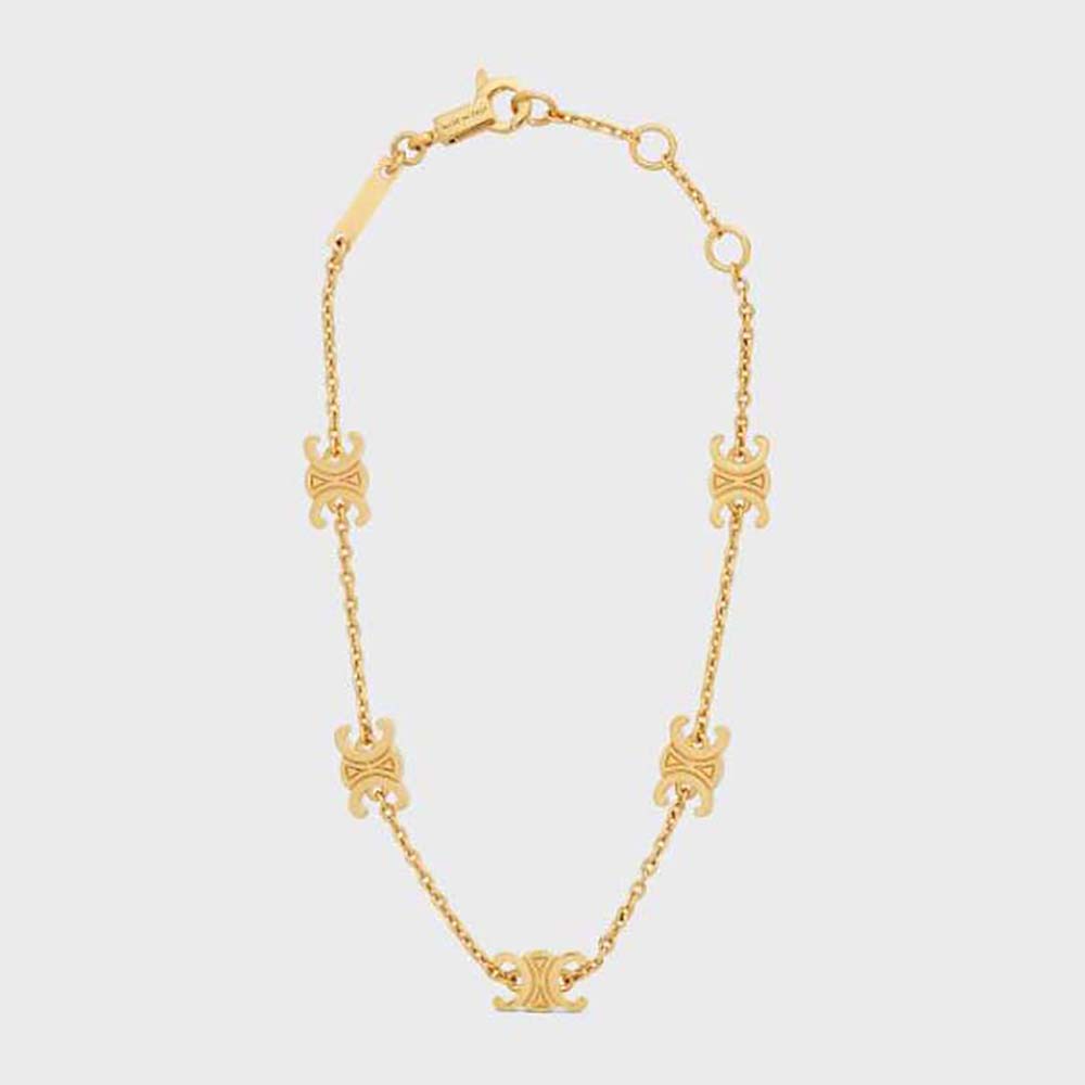 Close-up of Celine Women Triomphe Mini Triomphe Bracelet gold finish