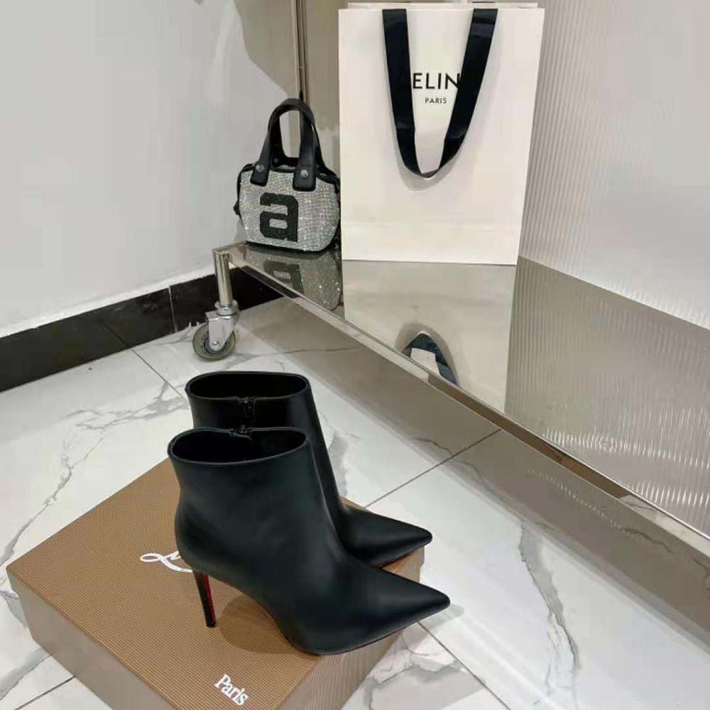 Detail of glossy black patent leather on Christian Louboutin So Kate Booty boots