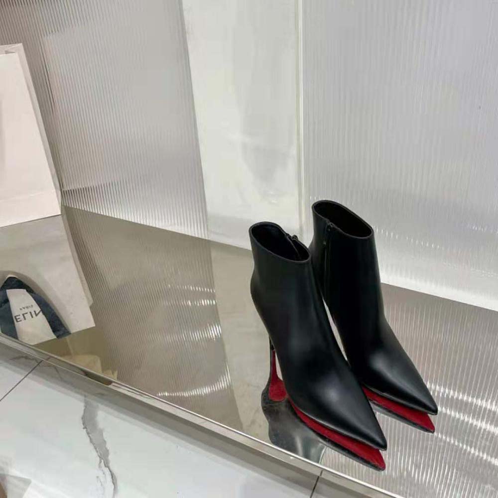 Close-up on signature red sole of Christian Louboutin So Kate Booty boots