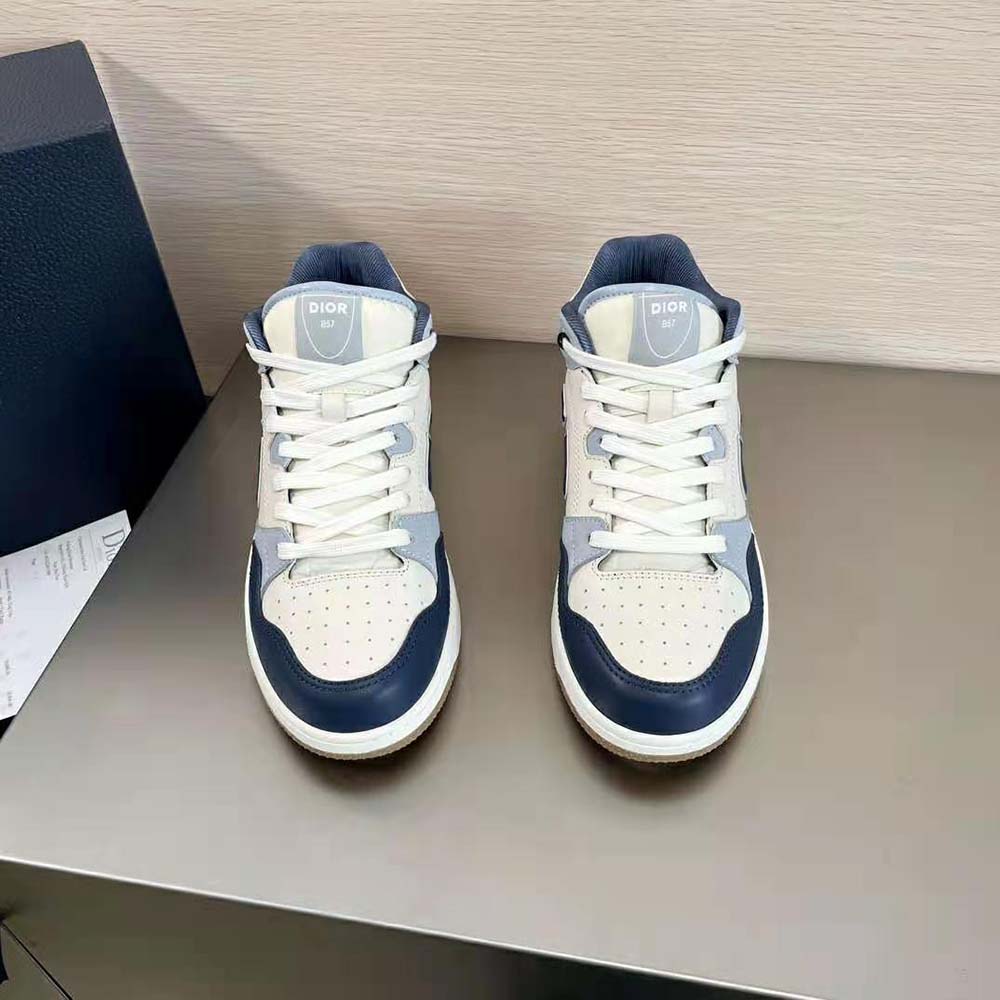 Close-up on gray suede and signature Dior hardware of B57 Mid-Top Sneaker