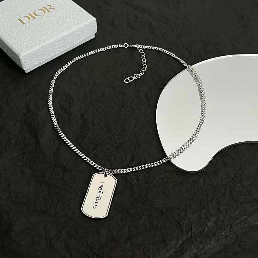 Close-up of silver-finish brass CD plate detail on Dior Men necklace
