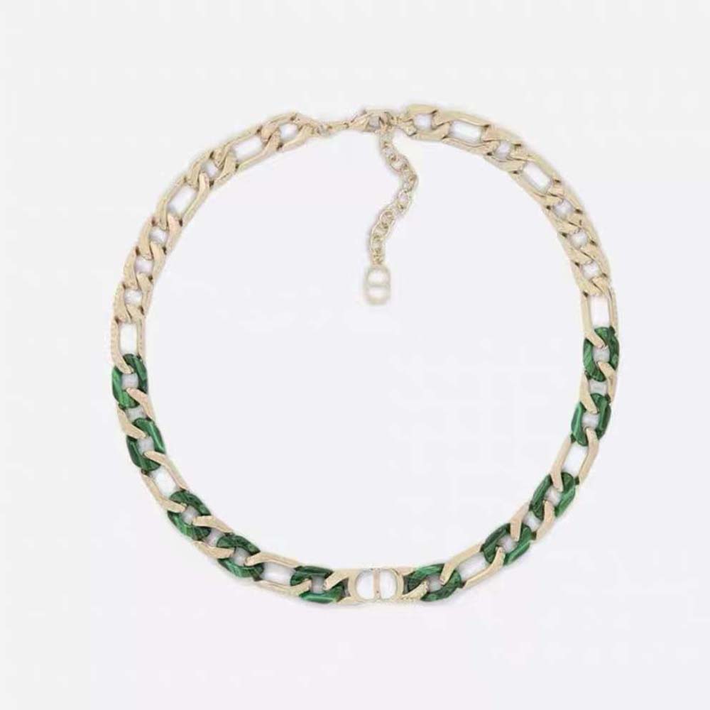 Close-up on green resin and gold-finish brass of Dior Men Tears Bracelet