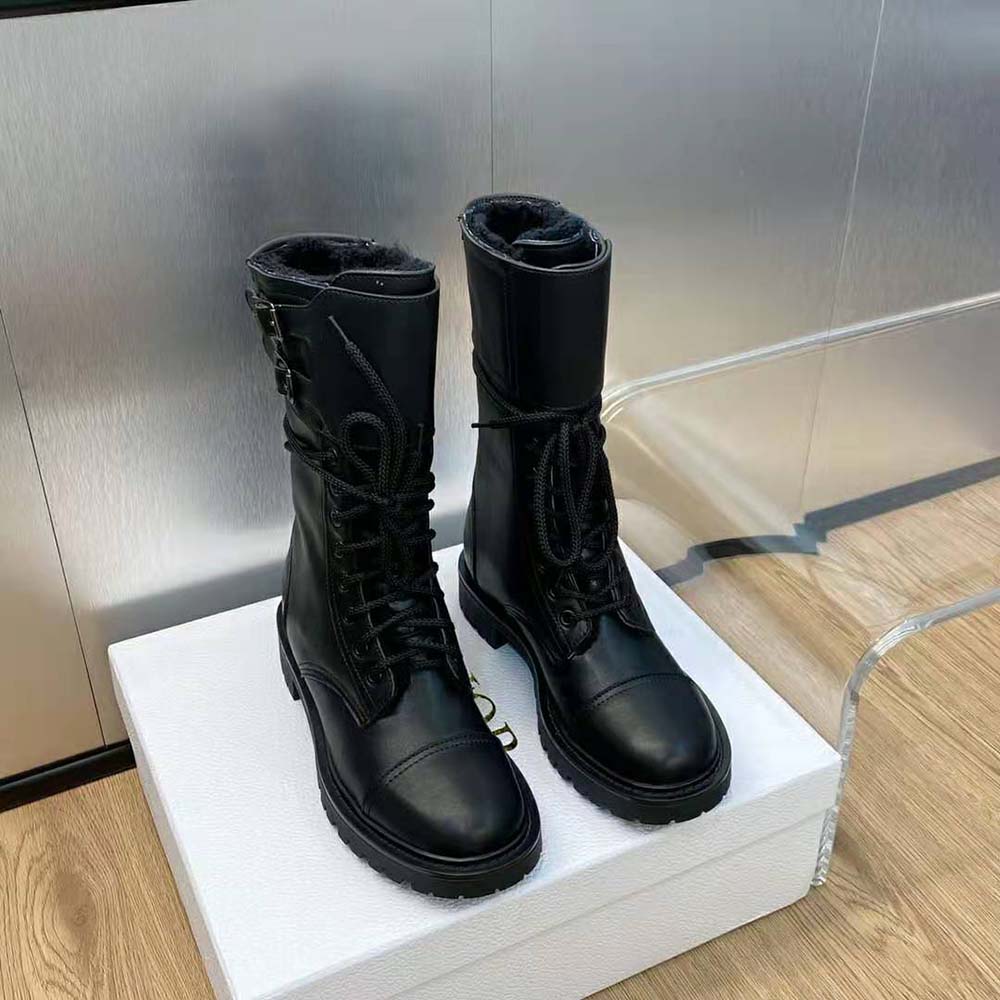 Close-up detail of silver Dior hardware on black calfskin boot
