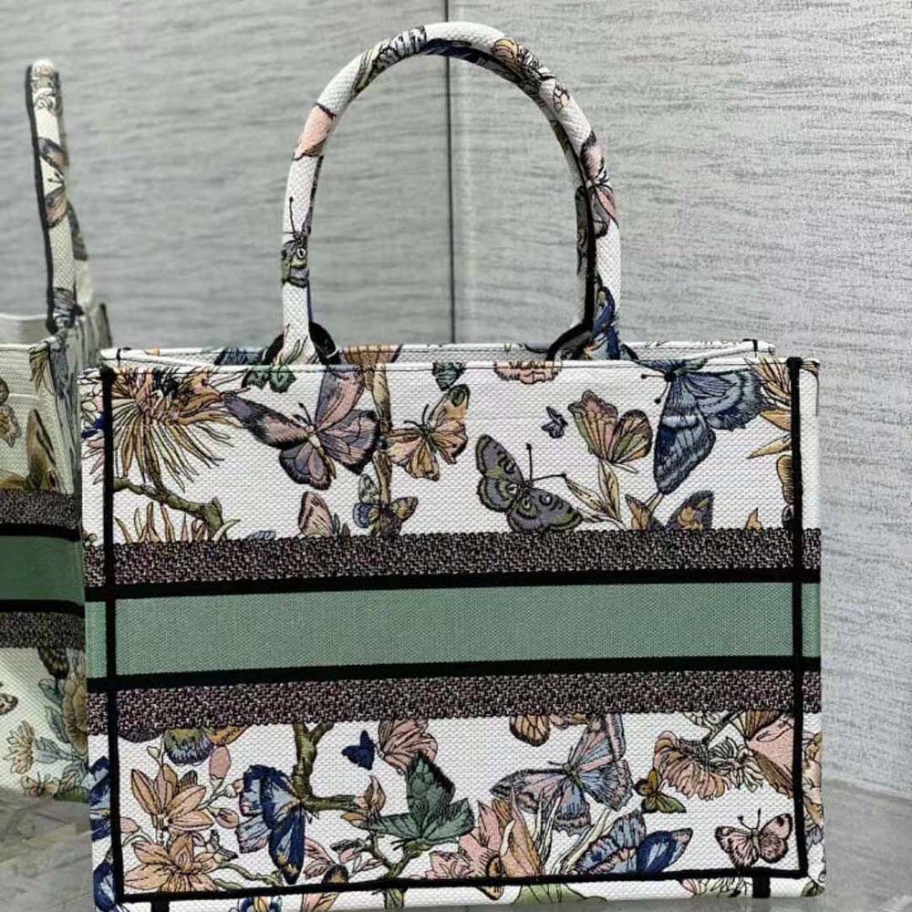 Side angle showing silver hardware and tote structure on Dior Women Medium Dior Book Tote