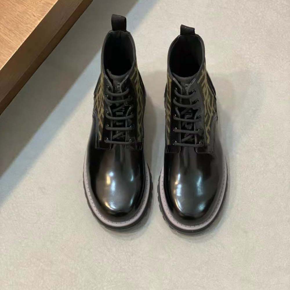 Close-up of Fendi branded metal hardware on black leather biker boots