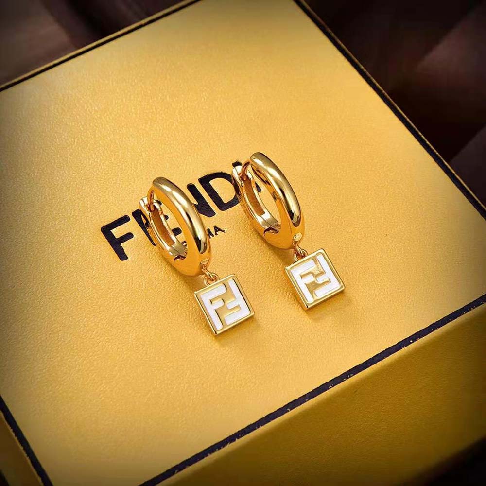 Close-up of white enamel and gold-colored metal on Fendi Women Forever Fendi Earrings