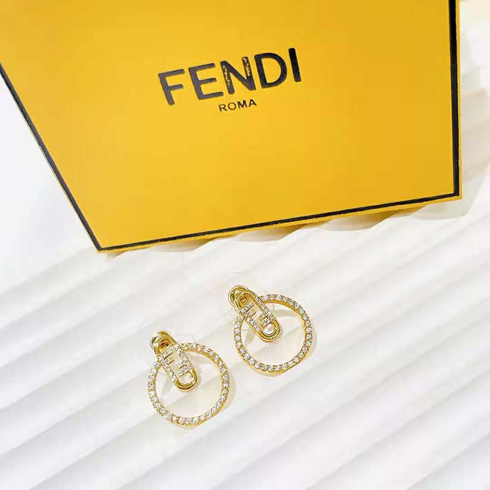 Close-up of gold-tone Fendi O’Lock motif on hoop earrings