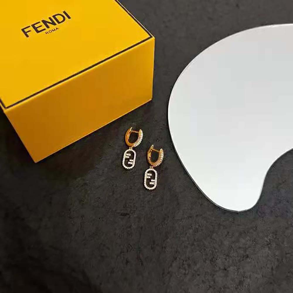 Side angle showing gold finish of Fendi Women Hoop Earrings with pendant