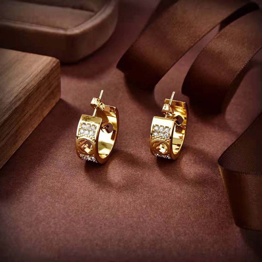 Side profile showing hinged closure of Fendi Women Small Hoop Earrings gold