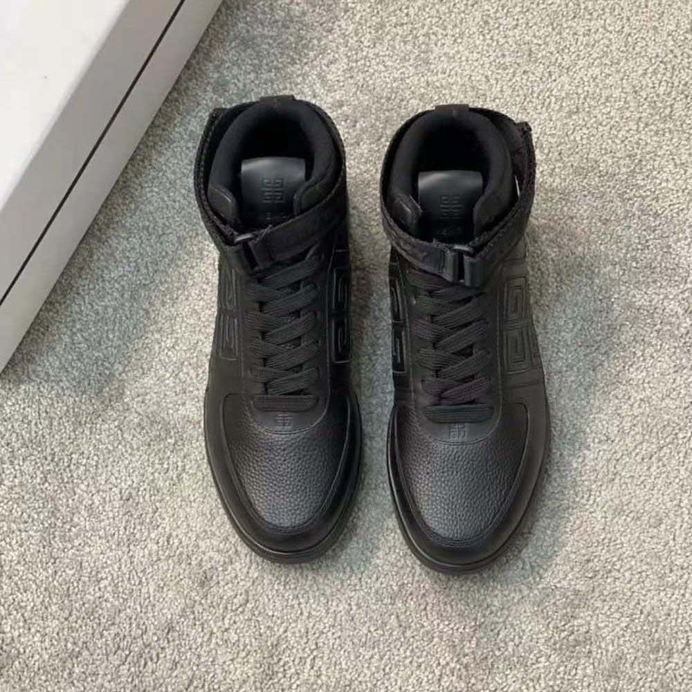 Close-up of black leather and Givenchy logo hardware on high top sneakers