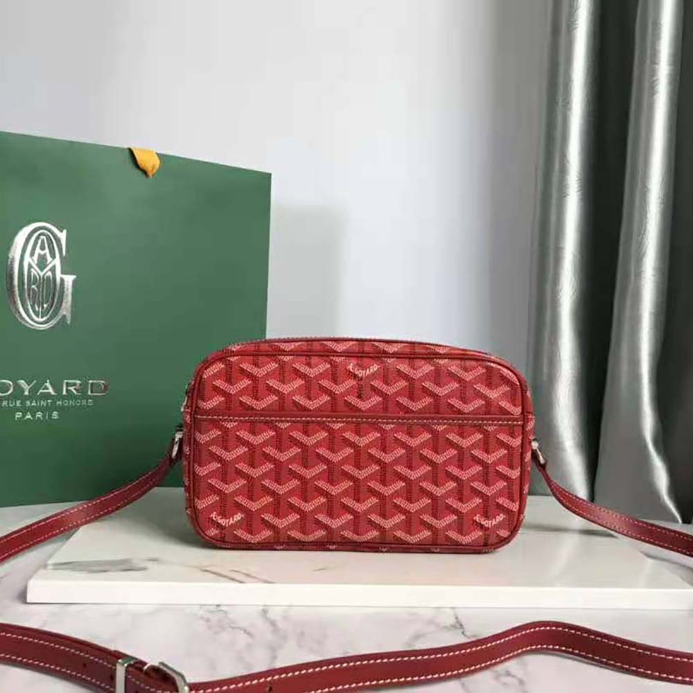 Close-up of Goyardine canvas and brass hardware on Cap-vert Pm Bag-Red