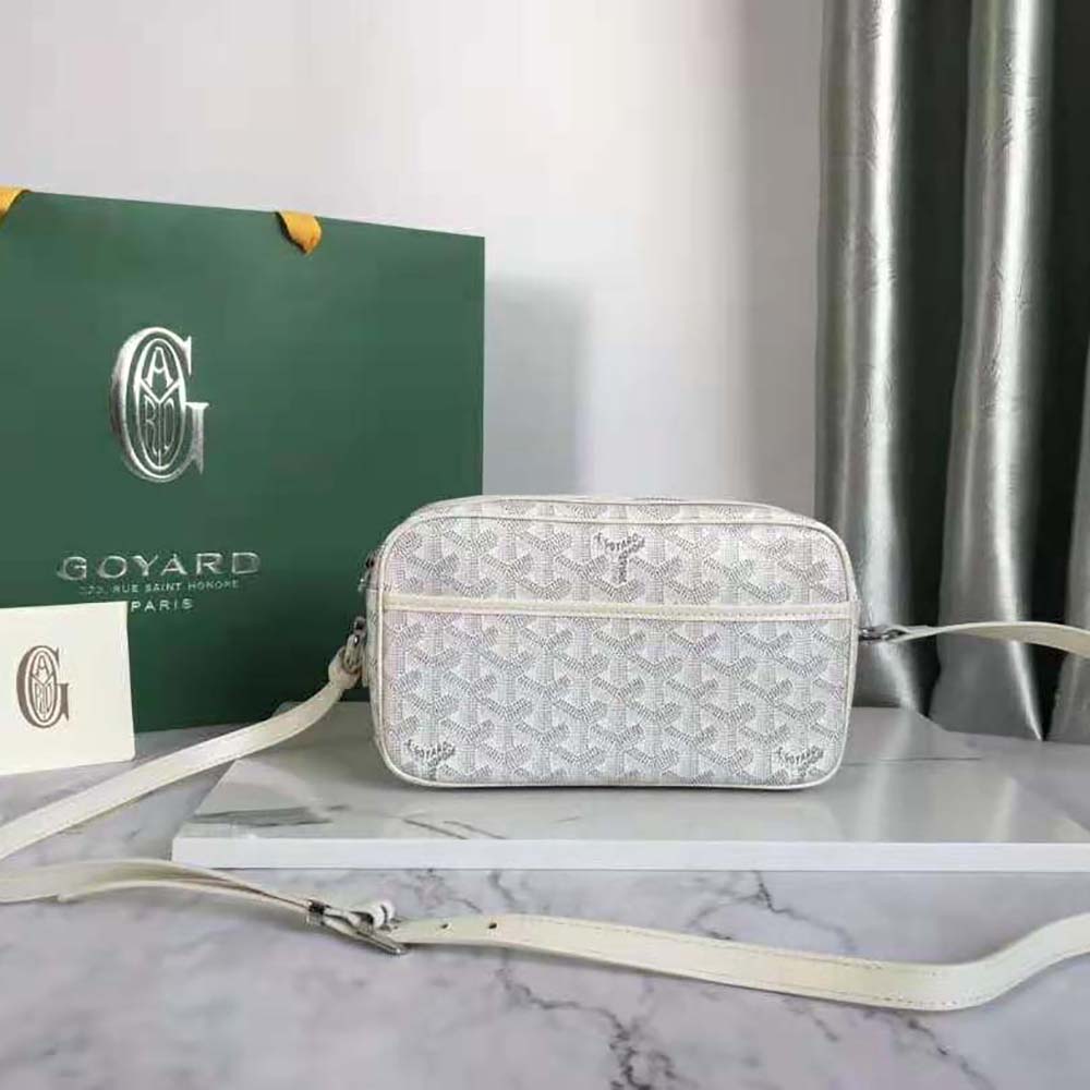 Close-up of white Goyard Cap-vert Pm Bag texture and brass hardware