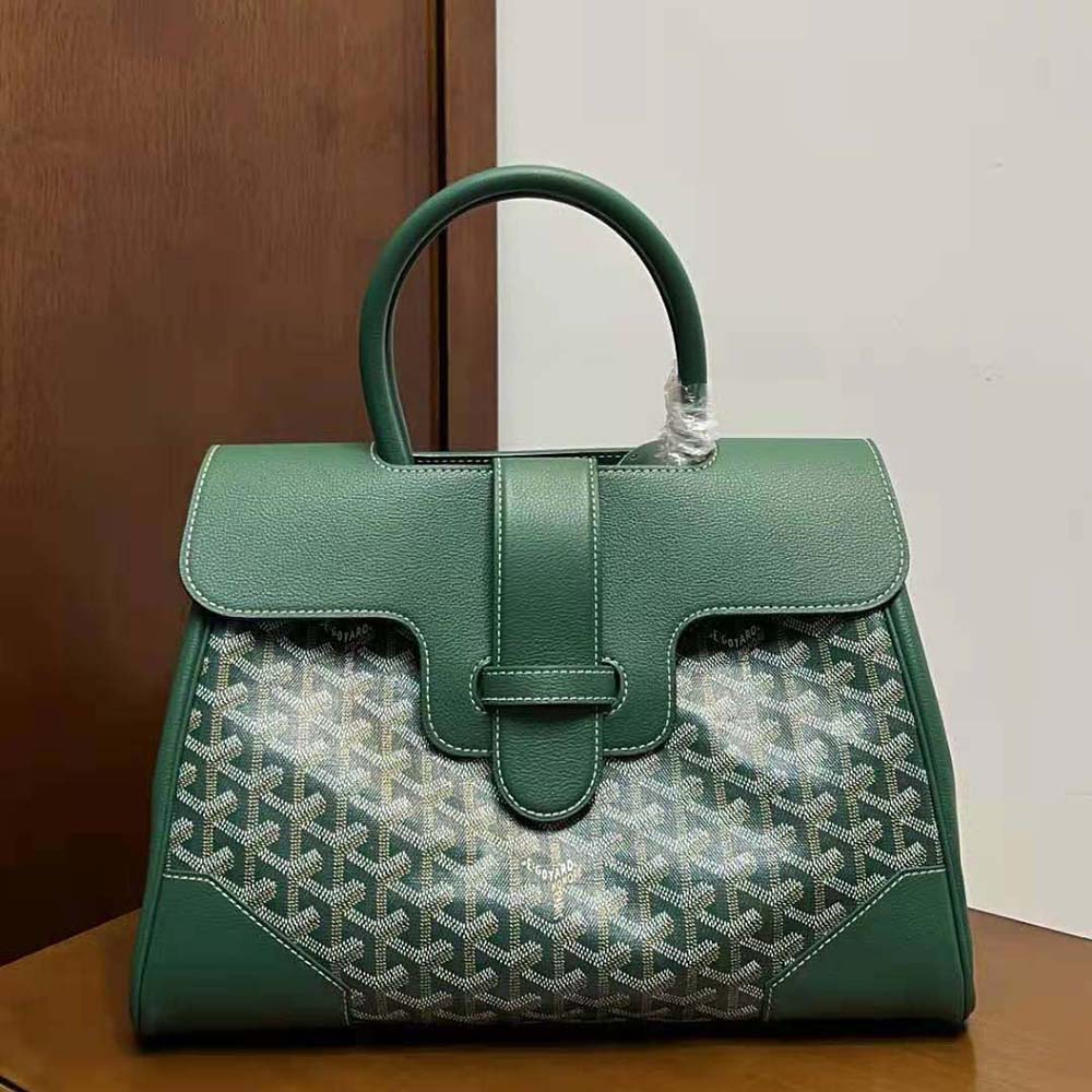 Close-up of green coated canvas and gold-tone hardware on the tote bag