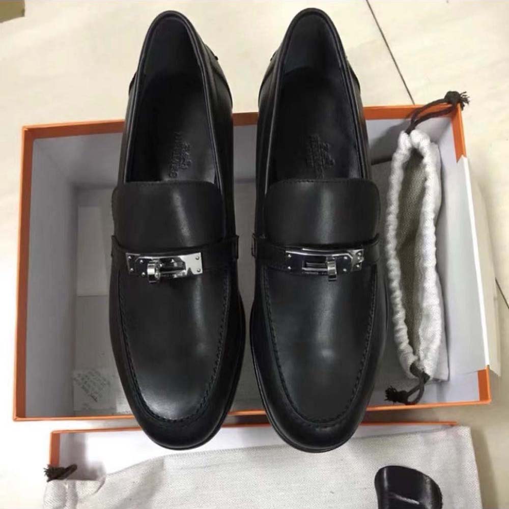 Close-up on black calfskin leather and Hermes logo hardware detail