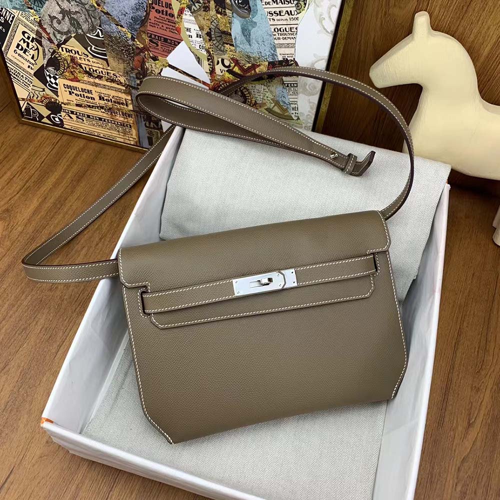Side profile showcasing slim silhouette of Hermes Men Kelly Depeches 25 Pouch-Gray