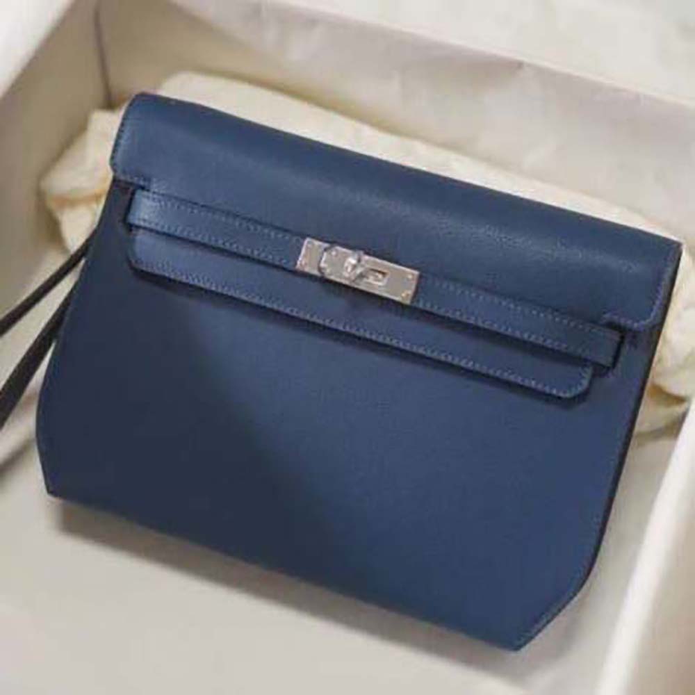 Close-up of navy leather texture and gold-tone Kelly clasp detail