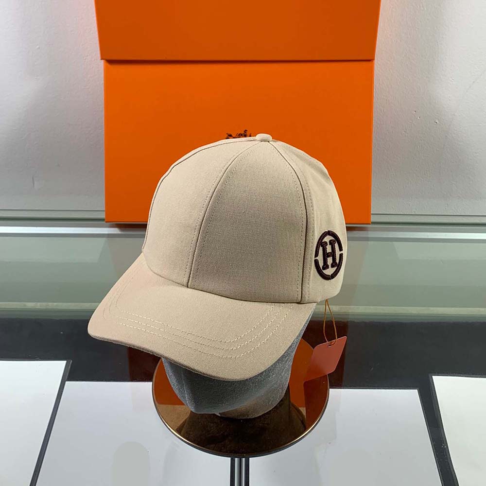 Front view of Hermes Men Miles H Circle Cap in beige cotton