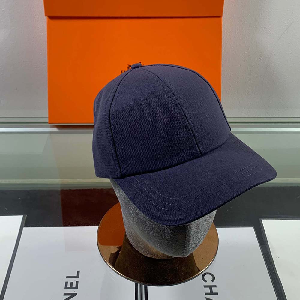 Close-up of brushed silver H Circle emblem on Hermes cap
