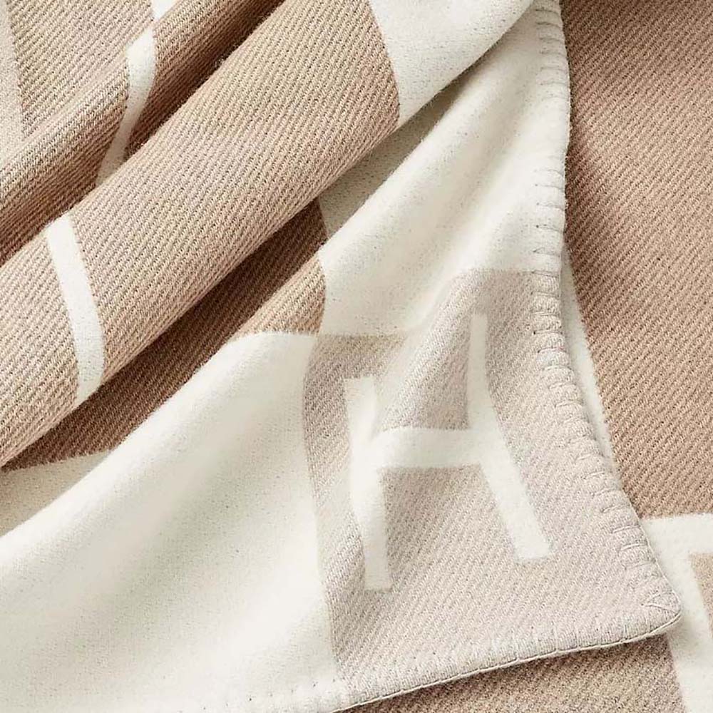 Full view of Hermes Unisex Avalon Vibration Throw Blanket-Brown draped on sofa