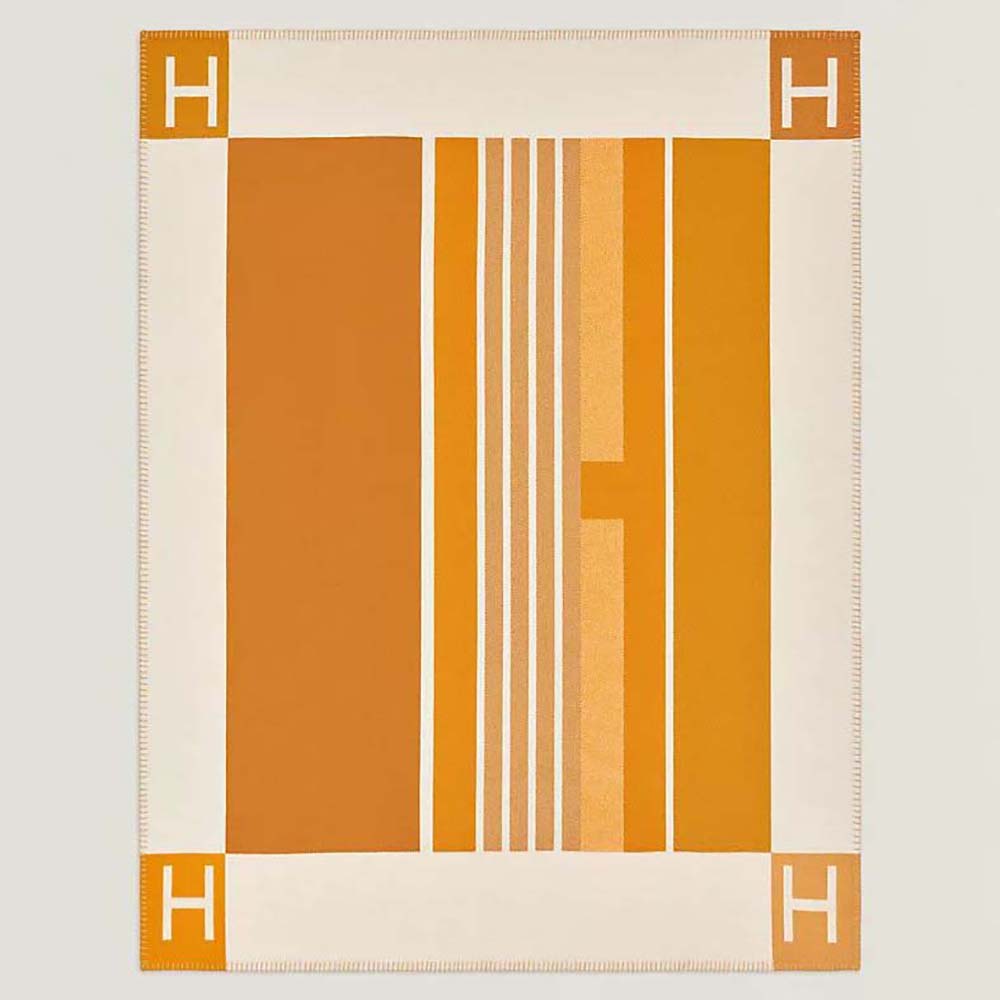 Front view of Hermes Unisex Avalon Vibration Throw Blanket-Orange on sofa