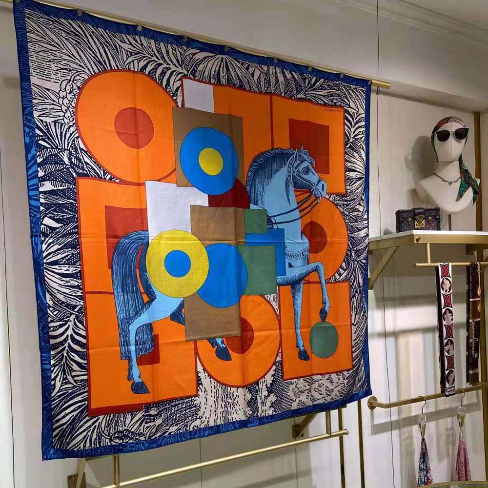 Close-up of signature print on Hermes Women Cavalier En Formes Scarf 90-Orange
