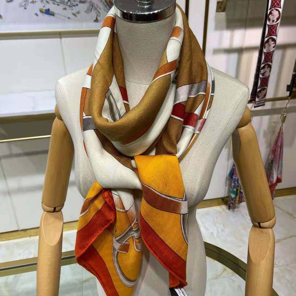 Detail of vibrant orange design pattern on Hermes Women Figure Artistique Scarf 90-Orange