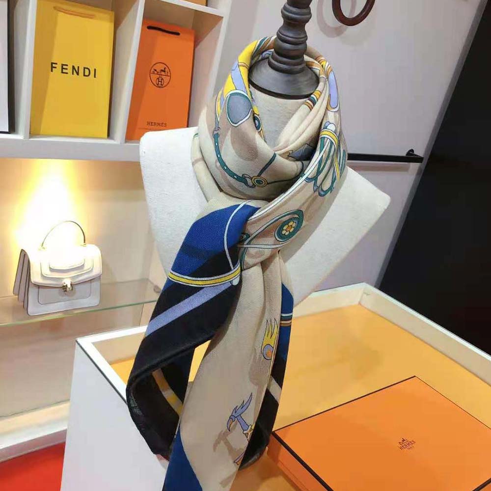 Styled shot showing navy Hermes Women Voitures En Equilibre Shawl 140 worn over shoulders
