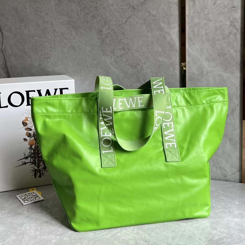 Close-up of green leather texture and gold hardware on Loewe Fold Shopper