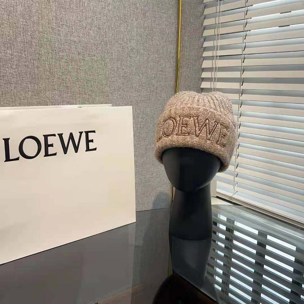 Close-up detail of embossed Loewe logo on wool beige beanie