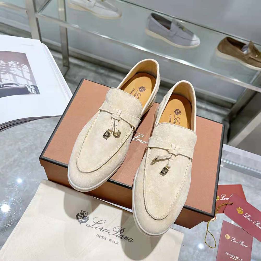 Close-up of gold charm hardware on Loro Piana Summer Charms Walk Loafers