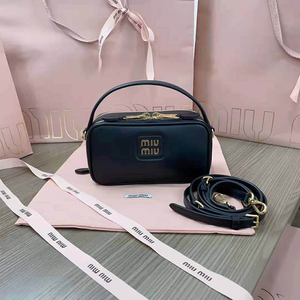 Close-up of polished silver-tone metal logo on Miu Miu Women Arcadie Leather Bag