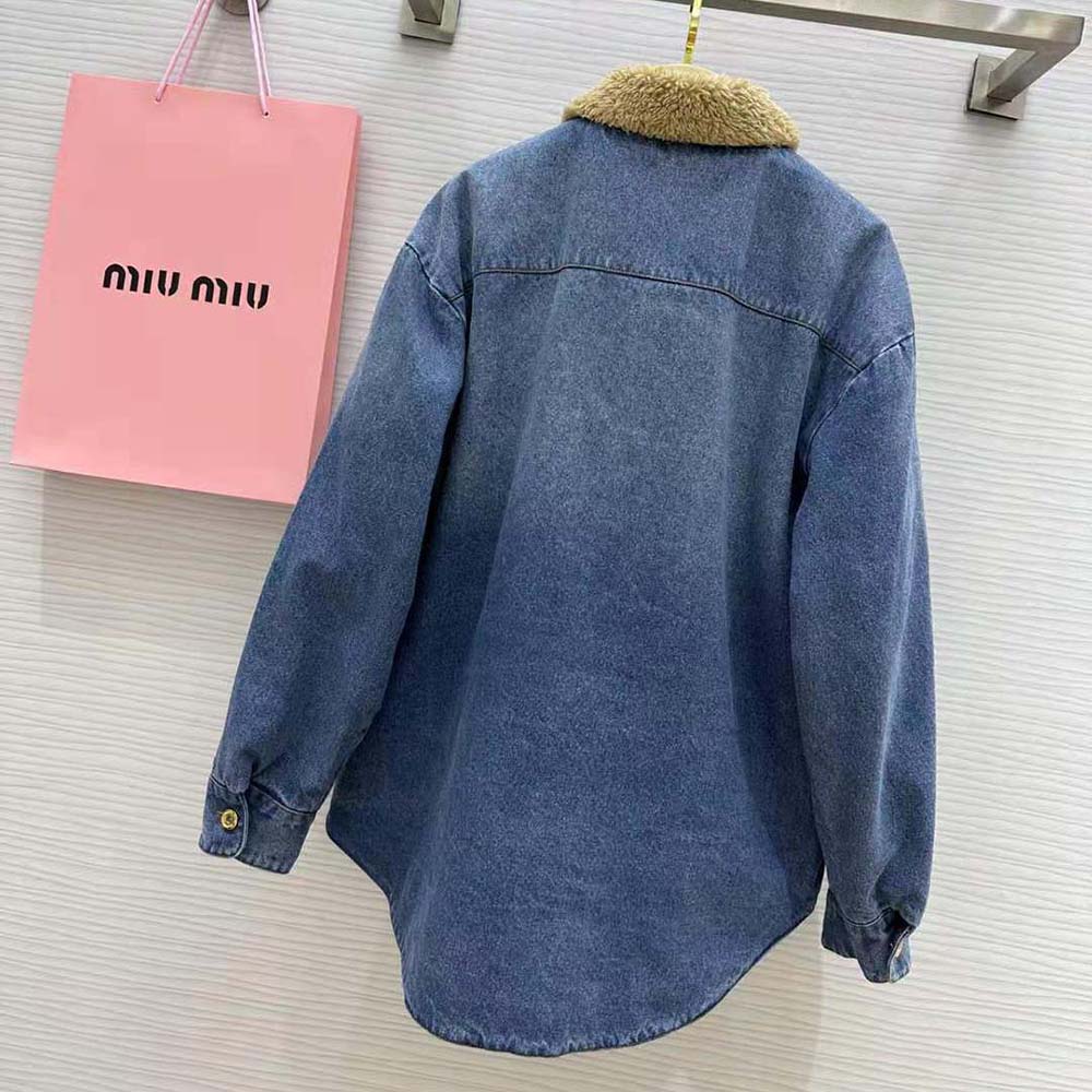 Side angle showing silhouette and silver hardware of Miu Miu embroidered denim jacket