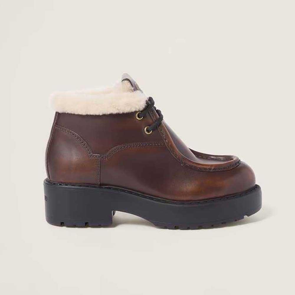 Side angle view of Miu Miu Women Fumé Leather Booties-Brown showing zipper