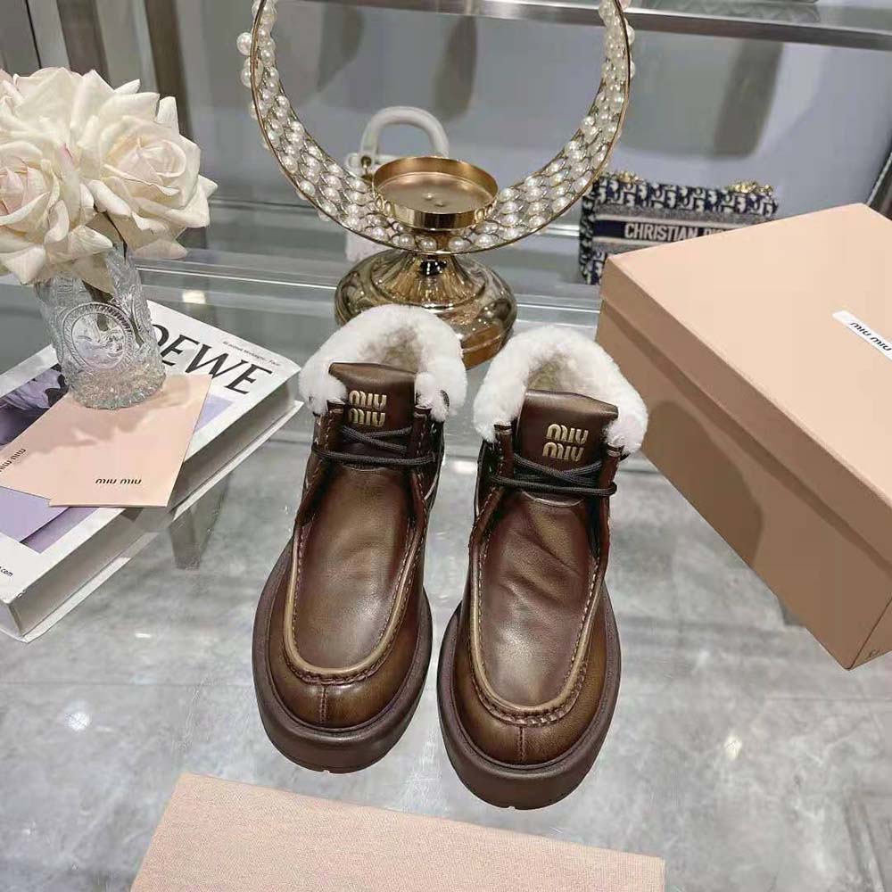 Close-up on brown fumé leather texture of Miu Miu Women Fumé Leather Booties-Brown