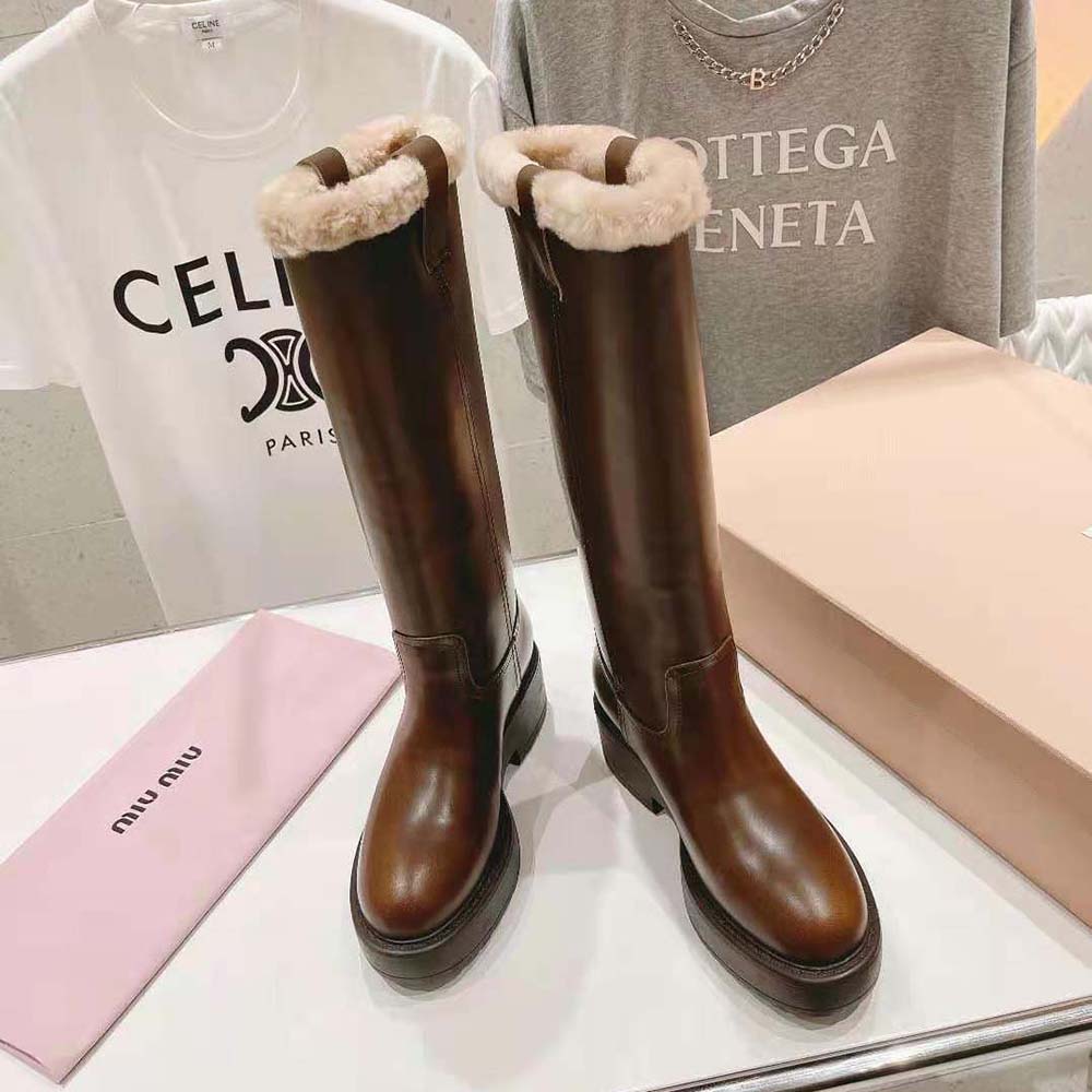 Front angle of Miu Miu Women Fumé Leather Boots-Brown highlighting gold hardware