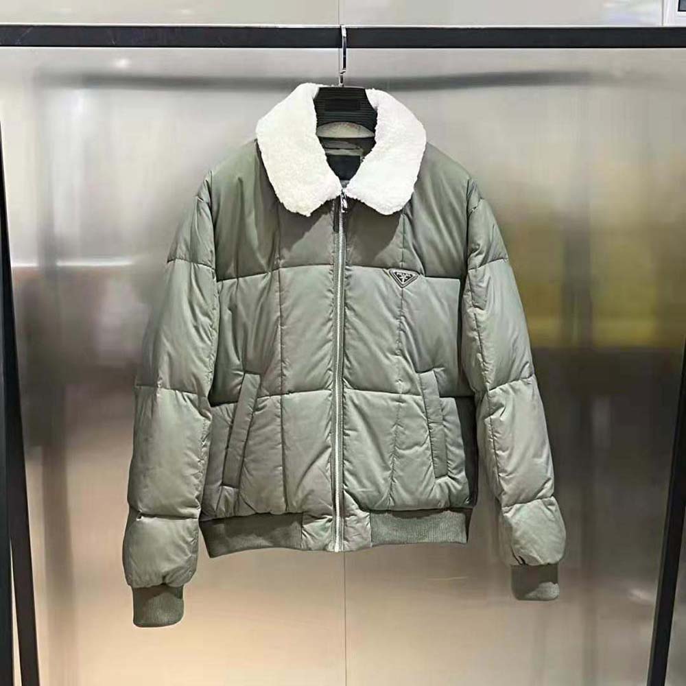 Close-up of Prada branded zipper on dark green cropped down jacket