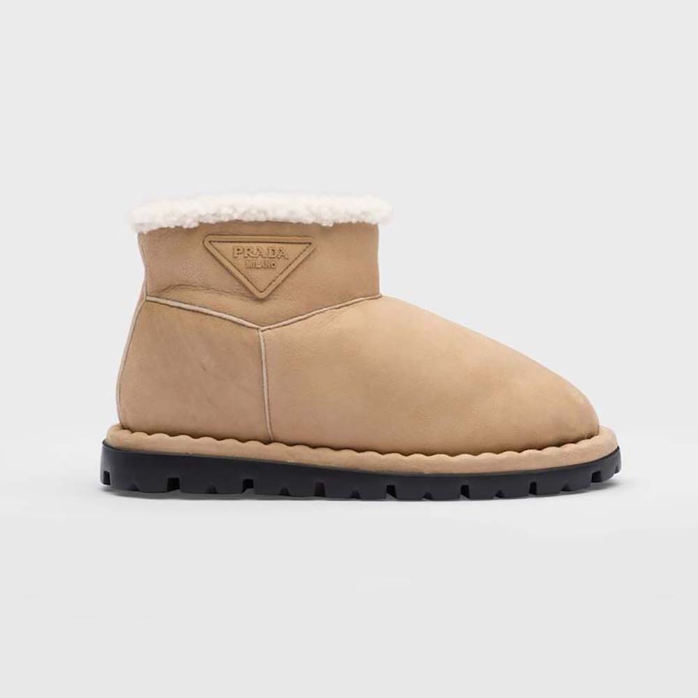 Side view of Prada Unisex Shearling Booties with beige shearling texture