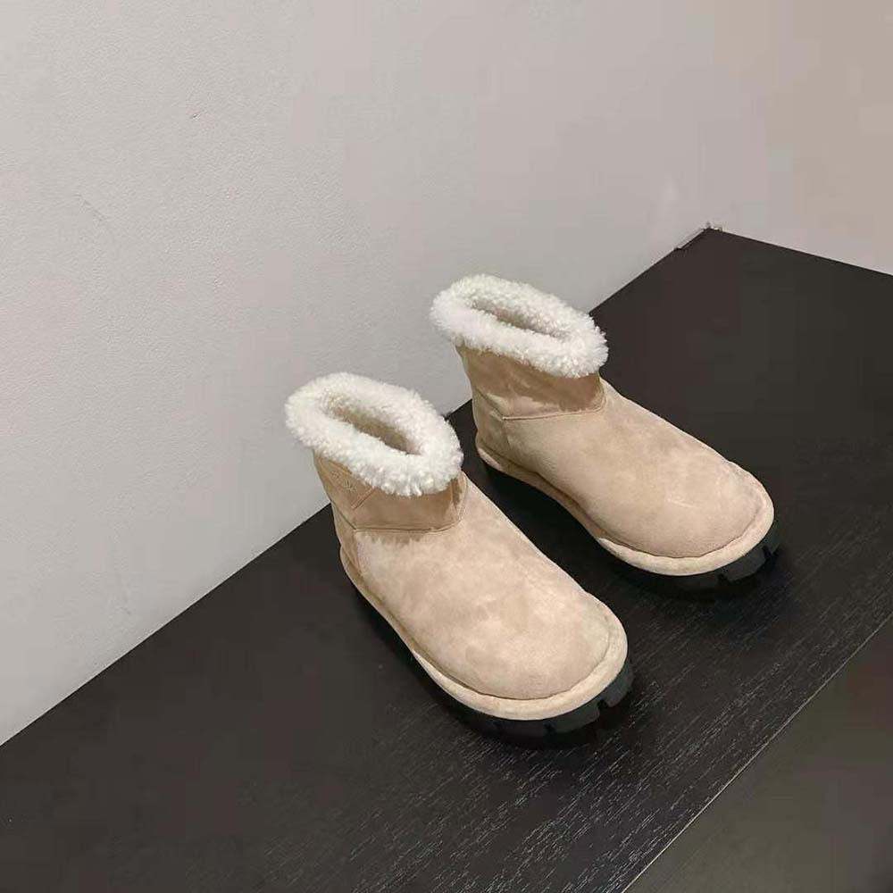 Close-up of rubber triangle logo on Prada Unisex Shearling Booties