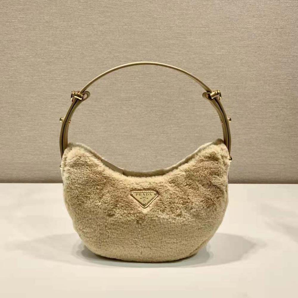 Side profile showing curved silhouette of Prada Women Arqué Shearling and Leather Shoulder Bag-Beige