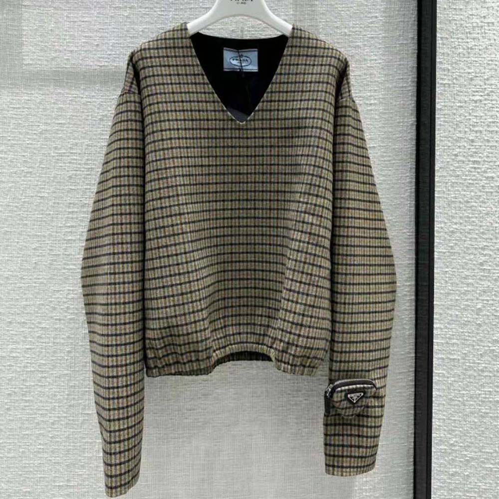 Close-up of brown check pattern and signature Prada triangle logo